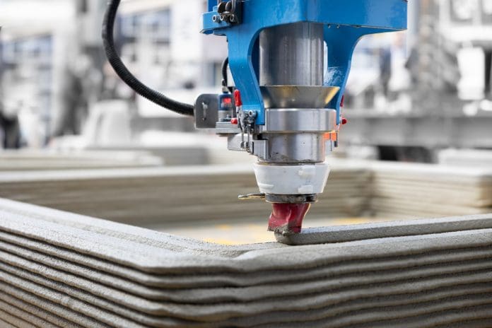 3D Concrete Printing A 3D printer producing a concrete building