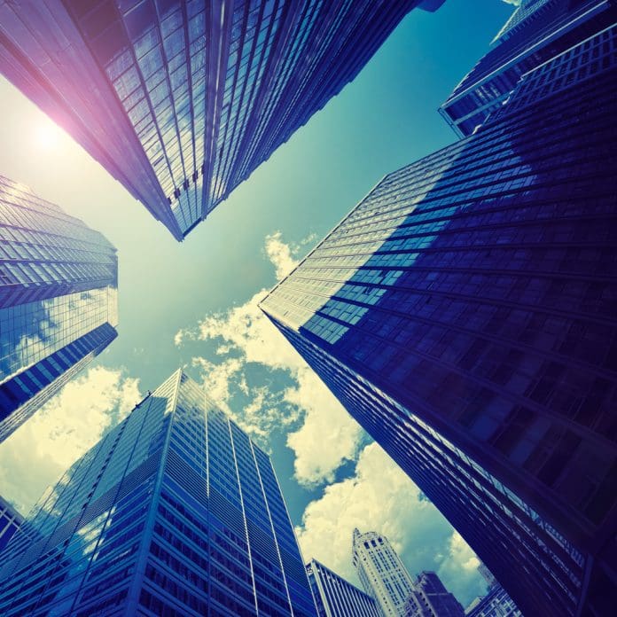 Blue tall Manhattan skyscraper against Sun Blue tall Manhattan skyscraper against Sun, downtown.