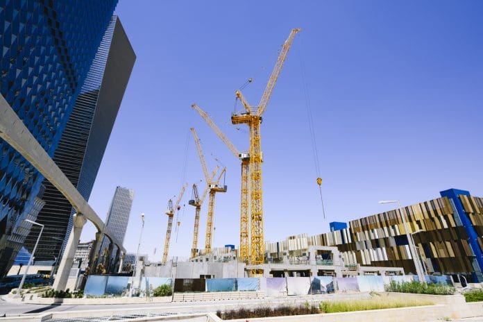 Construction site, King Abdullah Financial District EarthCam and WakeCap to collaborate on connected worker tech in Saudi Arabia. Five tower cranes on a construction site in Riyadh, Saudi Arabia