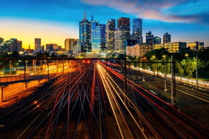 Melbourne train station with Melbourne city background Melbourne train station with Melbourne city background. Cross-border standardised approvals trial to boost innovation in infrastructure technology