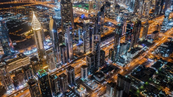 megacity-dubai-uae-1290941536 An aerial shot of Dubai, UAE, at night. Siemens Smart Infrastructure signs deal with UAE for decarbonization of government buildings