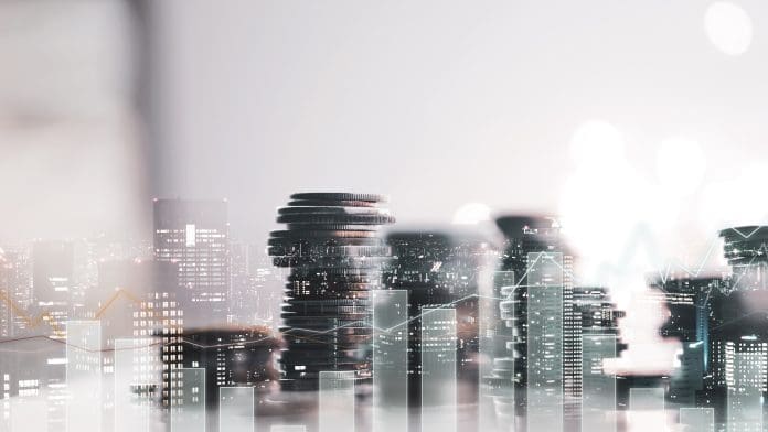 Double exposure of city view. diagram graph and rows of money coins for finance , money , investment and business concept background Start-up firm Comstruct has raised $13m in investment to support its software platform aimed at digitising construction materials procurement