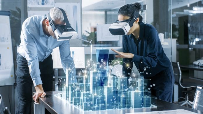 Male and Female Architects Wearing Augmented Reality Headsets Work with 3D City Model. High Tech Office Professional People Use Virtual Reality Modeling Software Application.